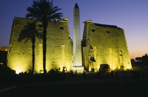 EGYPT, Upper Egypt, Luxor, The Temple Pylons with Obelisk and statues of Ramesses II illuminated at