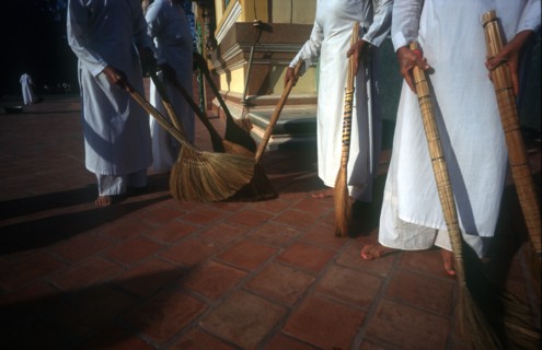 VIETNAM, Tay Ninh Province, Tay Ninh, Cropped view of temple sweepers.