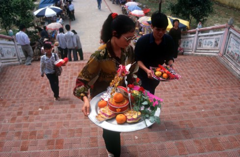 VIETNAM, Den Ba Chua Kho, "People making offerings of fruit, flowers, incense and money at the