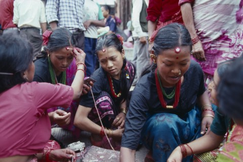 NEPAL, Religion, Young women receiving Tikas a mark of blessing on their forehead
