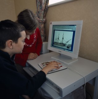 INDUSTRY, Computers, Children, Young boy and girl sitting at a home computer looking at educational