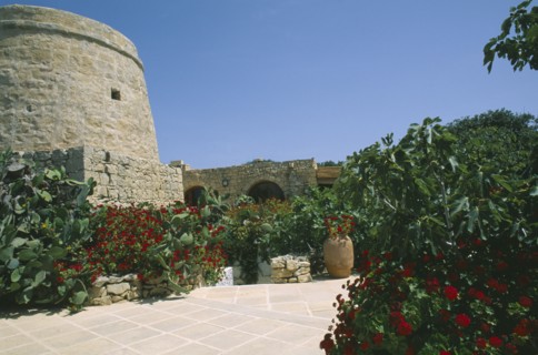 MALTA, Gozo, Ta’ Cenc, Entrance to Ta’ Cenc Hotel with traditional grain store and lined with