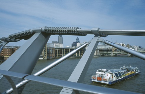 ENGLAND, London, Section of the Millennium footbridge with passing tour boat