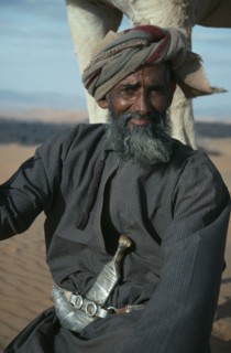 OMAN, Wahiba Sands, People, "Man wearing a khanjar, a traditional curved dagger attached to his