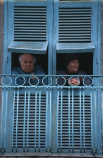 ITALY, Campania, Naples, San Giorgio a Cremano.  Elderly couple looking out from turquoise open