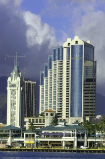 USA, Hawaii, Honolulu, Aloha Towers hotel seen over water