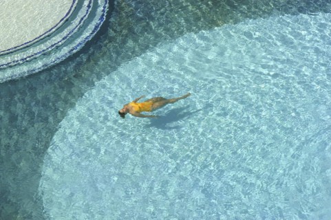 WEST INDIES, Dutch Antilles, Aruba, Aerial view looking down on clear blue swimming pool with