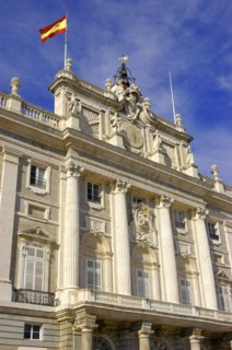 SPAIN, Madrid, Angled view looking up at the Palacio Real facade with the Spanish flag flying from