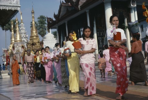 MYANMAR, Yangon, Shwedagon Pagoda.  Line of young women with offerings.