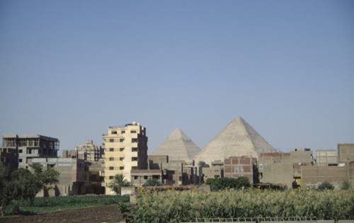 EGYPT, Cairo, City suburbs encroaching on the Pyramids at Giza.