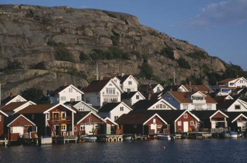SWEDEN, Hunnebostrand, Traditional red painted houses beside the quay at the fishing village