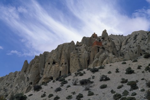 NEPAL, Mustang, Lori Gompa Caves  with small red building atop
