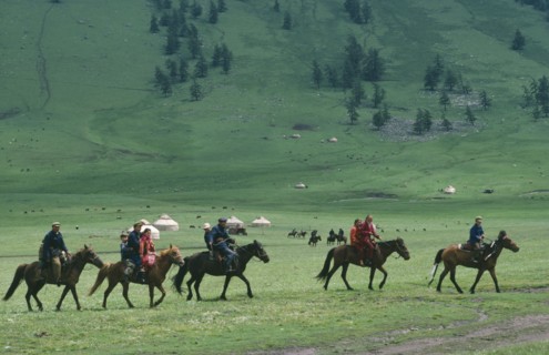 CHINA, Xinjiang Province, Kazakhs, Kazakh people on horseback on their way to the horse races
