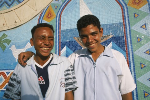 EGYPT, Nile Valley, Aswan, "Two smiling boys, one with arm resting across shoulders of other. "