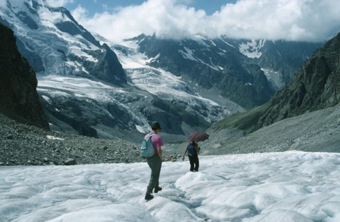 RUSSIA, Caucasus Mountains, Adyr Su Valley, Hikers walking down glacier wearing sun glasses and