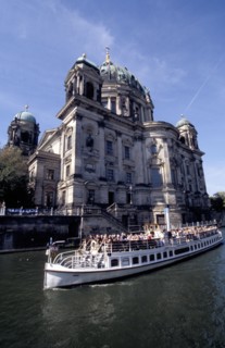 GERMANY, Berlin, Berlinerdom with passing tourist boat