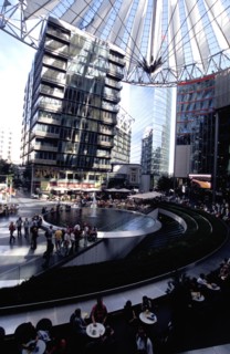 GERMANY, Berlin, Potsdamer Platz. Sony complex interior with crowds gathered around central water