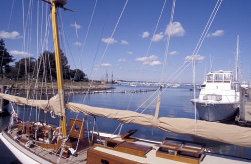 USA, Massachusetts, Plymouth, View over moored boats in the harbour with the Mayflower 2 in the
