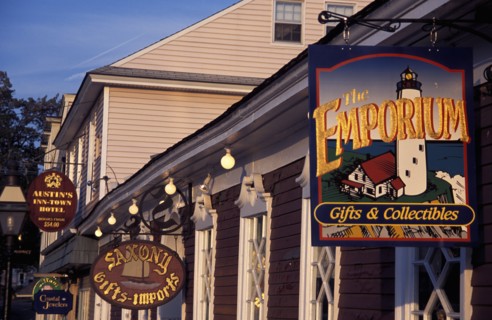 USA, Rhode Island, Newport, View along row of gift shop facades with hanging signs