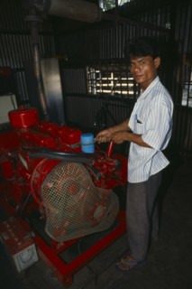 BANGLADESH, Mymensingh, Mechanic maintaining diesel generator.