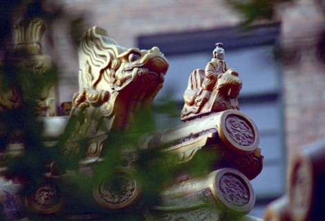 CHINA, Shandong, Qufu, Close up of decorative roof carvings in the ancient grounds where Confucius