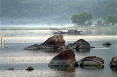 VIETNAM, Central, Lang Co, View over the rocky lagoon with passing boat