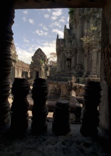 CAMBODIA, Angkor, View through archway over pink sandstone ruins of Banteay Srei or The Citadel of