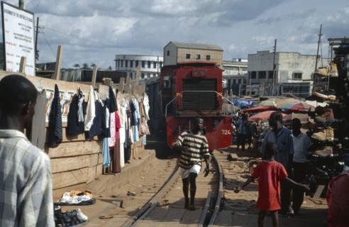 GHANA, Kumasi, Train running through busy market