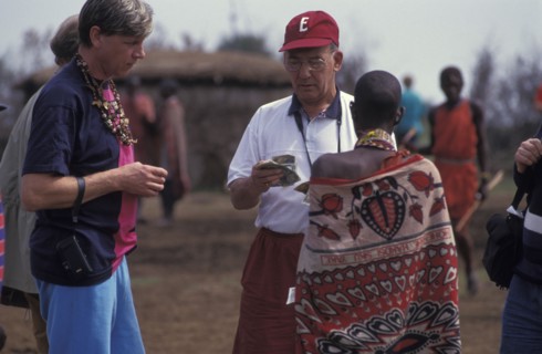 KENYA, , An American tourist haggles with a Maasai woman in a cultural manyatta set up to interface