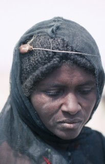 ETHIOPIA, Danakil Depression, Portrait of Afar woman with verses of the Koran tied around her head