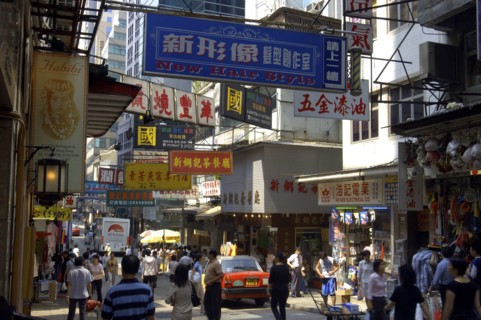 HONG KONG, General, View along busy city street with passing traffic and pedestrians and overhead