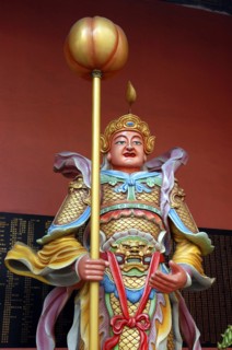 MALAYSIA, Kuala Lumpur, Chinatown, Colourful statue of a figure holding a staff
