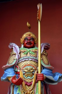 MALAYSIA, Kuala Lumpur, Colourful statue of a figure holding a staff