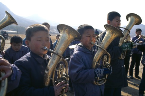 NORTH KOREA, Hwanghae Bukto, Juche ideology.  Pyongsan County band encouraging workers as they