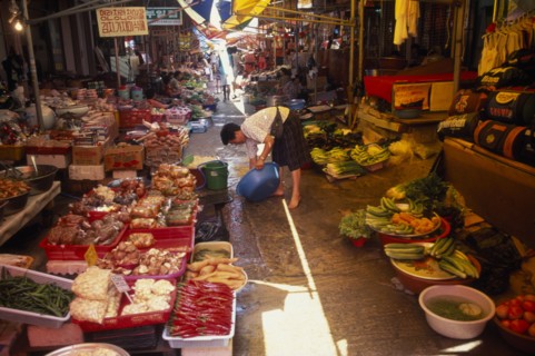 SOUTH KOREA, Kangwon, Sokcho, Women rinsing bowl at street market selling fruit and vegetables and
