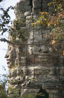 CAMBODIA, Siem Reap, Angkor, Ta Prohm monastic complex detail of the four faced west gate seen
