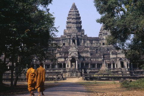 CAMBODIA, Siem Reap, Angkor Wat, Two monks walking on the east road leading to the rear of the main