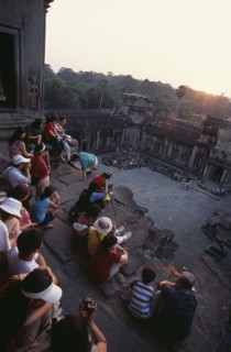 CAMBODIA, Siem Reap Province, Angkor Wat, Tourists with cameras watching the sunset from the
