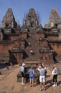 CAMBODIA, Siem Reap Province, Angkor, Preah Rup.  Western tourists with guide at cremation pit in