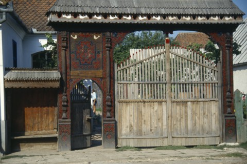 ROMANIA, Transylvania, Woodcarvers house with elaborately carved gateway decorated with plant and