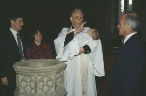 ENGLAND, Yorkshire, Religion, Church of England baptism.  Priest makes sign of the cross on the