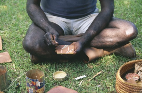AUSTRALIA, Northern Territory, Manyallaluk, Aborigine demonstrating tradition bark painting