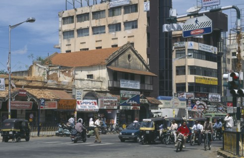 INDIA, Karnataka, Bangalore, Street scene.  Traffic at traffic lights with old and modern