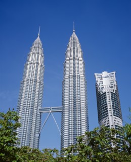 MALAYSIA, Kuala Lumpur, Petronas Twin Towers. Angled view looking up at the multi storey buildings