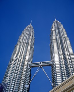MALAYSIA, Kuala Lumpur, Petronas Twin Towers. Angled view looking up at the multi storey buildings