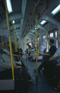 20059178 ENGLAND  London The London Underground. Interior view through the train carriage with passengers sitting on seats.