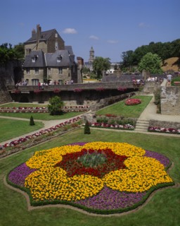 FRANCE, Brittany Morbihan, Vannes, Hermine Castle walls and formal gardens with colourful flowerbed