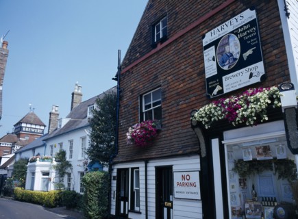 20059216 ENGLAND East Sussex Lewes John Harvey Brewery sign on the side of The Brewery Shop Wall in Cliff High Street with the brewery yard further down the road in the distance.