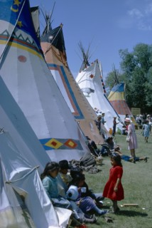 CANADA, Alberta, Calgary, Colourful Native North American Indian Tepees with people gathered on