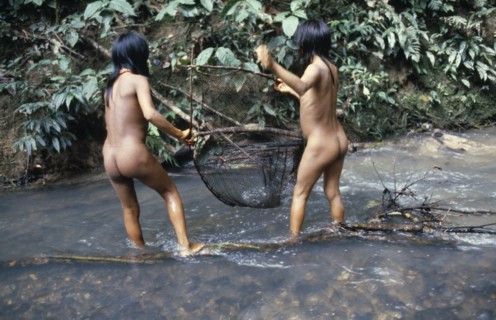 ECUADOR, Amazon, Auca, Two Auca Indian girls fishing with net.